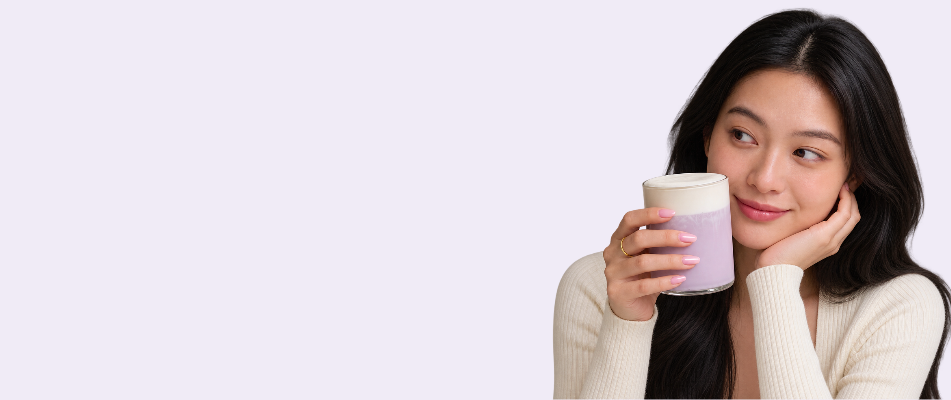 Woman holding a creamy ube latte made with Ube Nolia ube powder