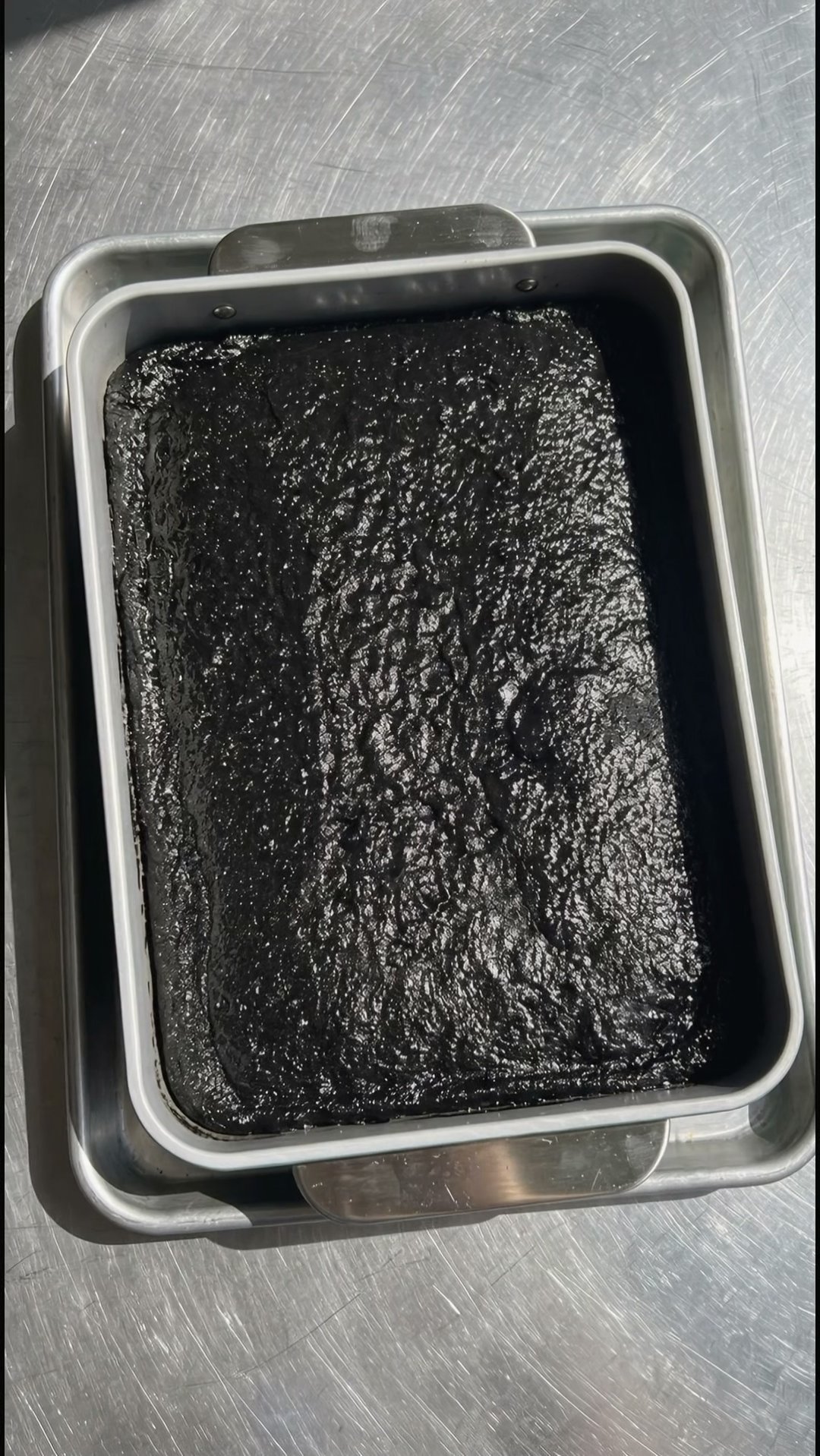 Baked black velvet cake base resting in its rectangular pan before adding ube frosting by Ube Nolia