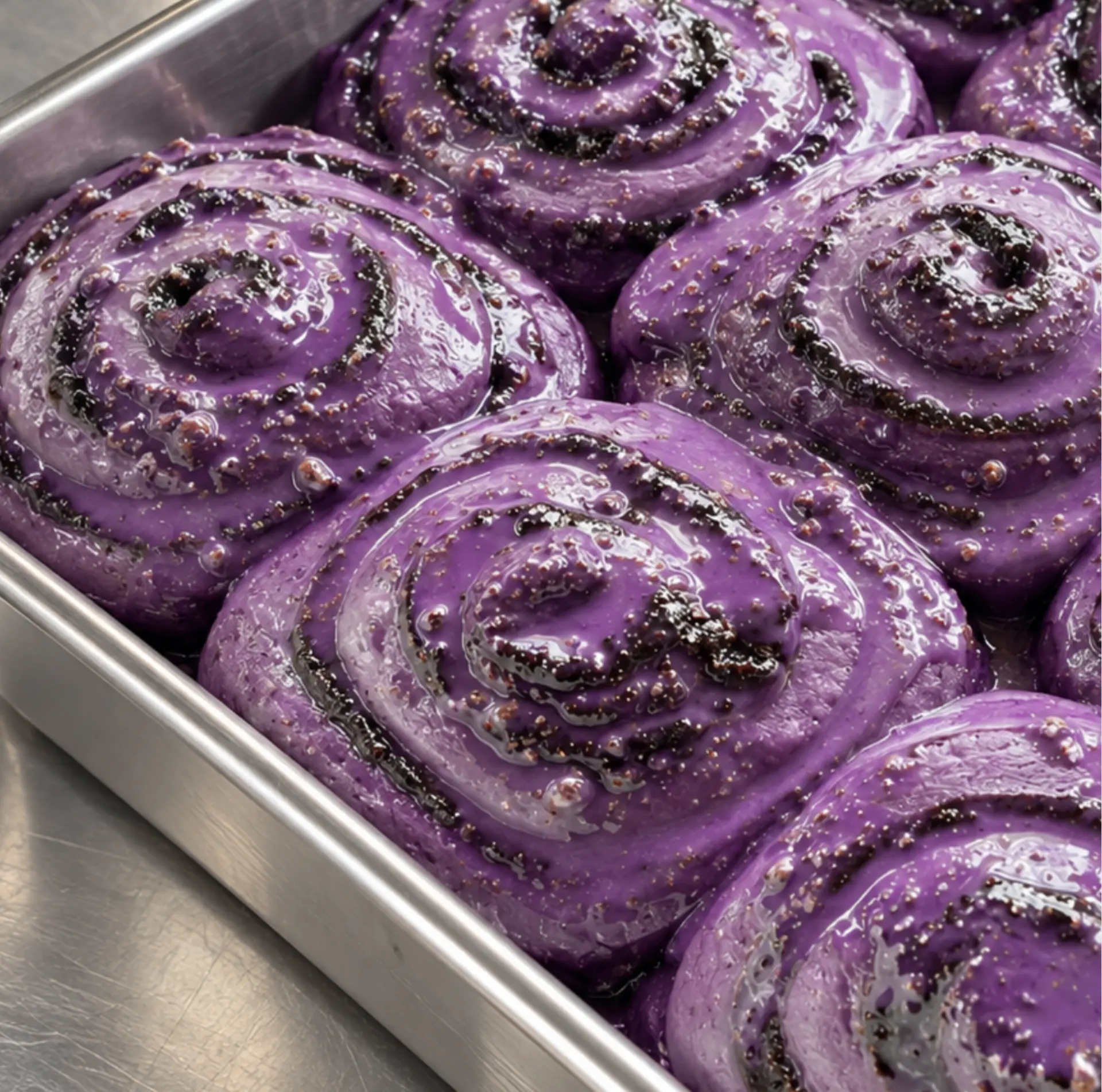 12 raw Ube Nolia ube cinnamon rolls in a dish, with an ube and cinnamon swirl, ready to bake at 175°C