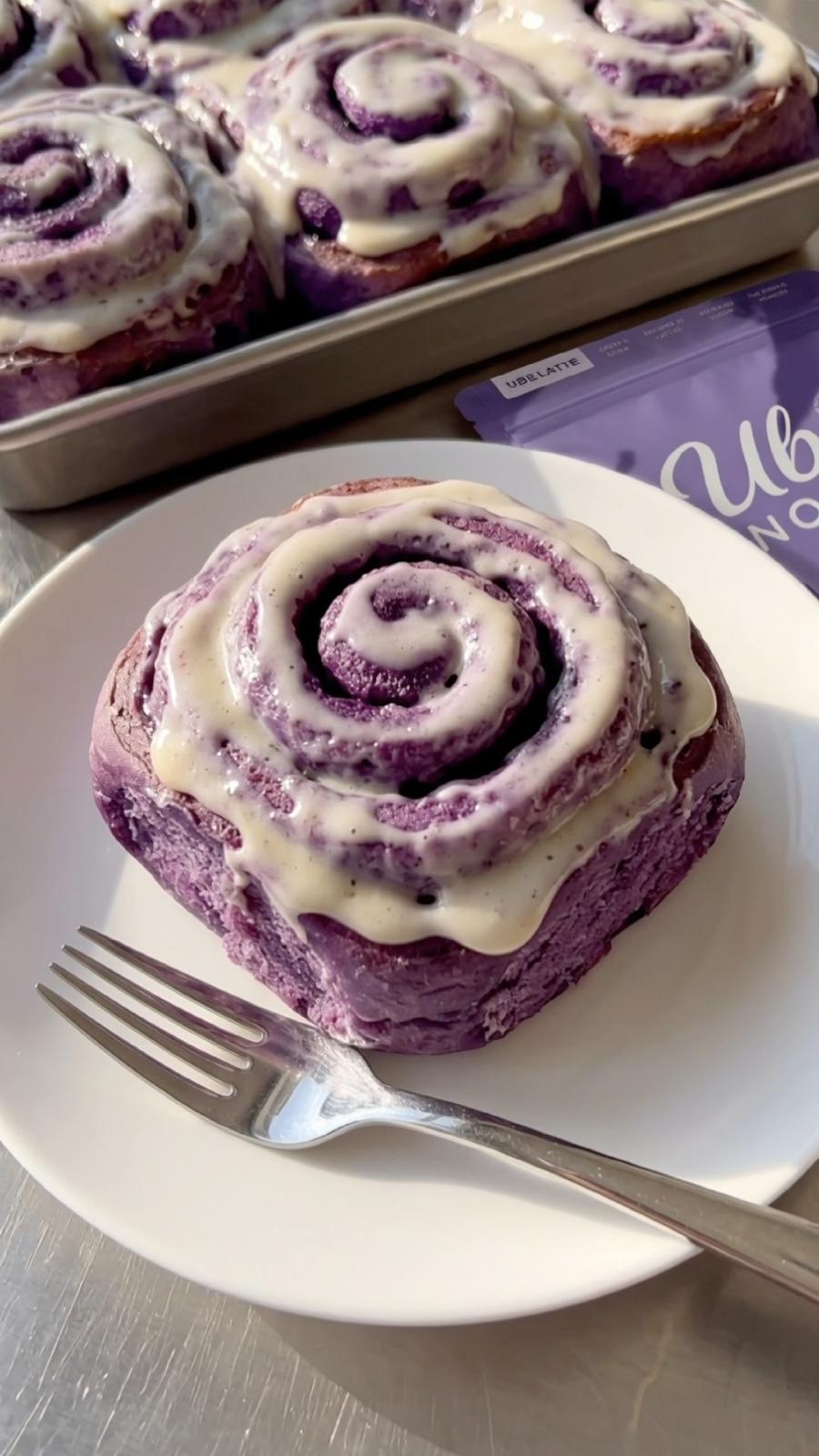 Baked Ube Nolia ube cinnamon roll topped with cream cheese frosting