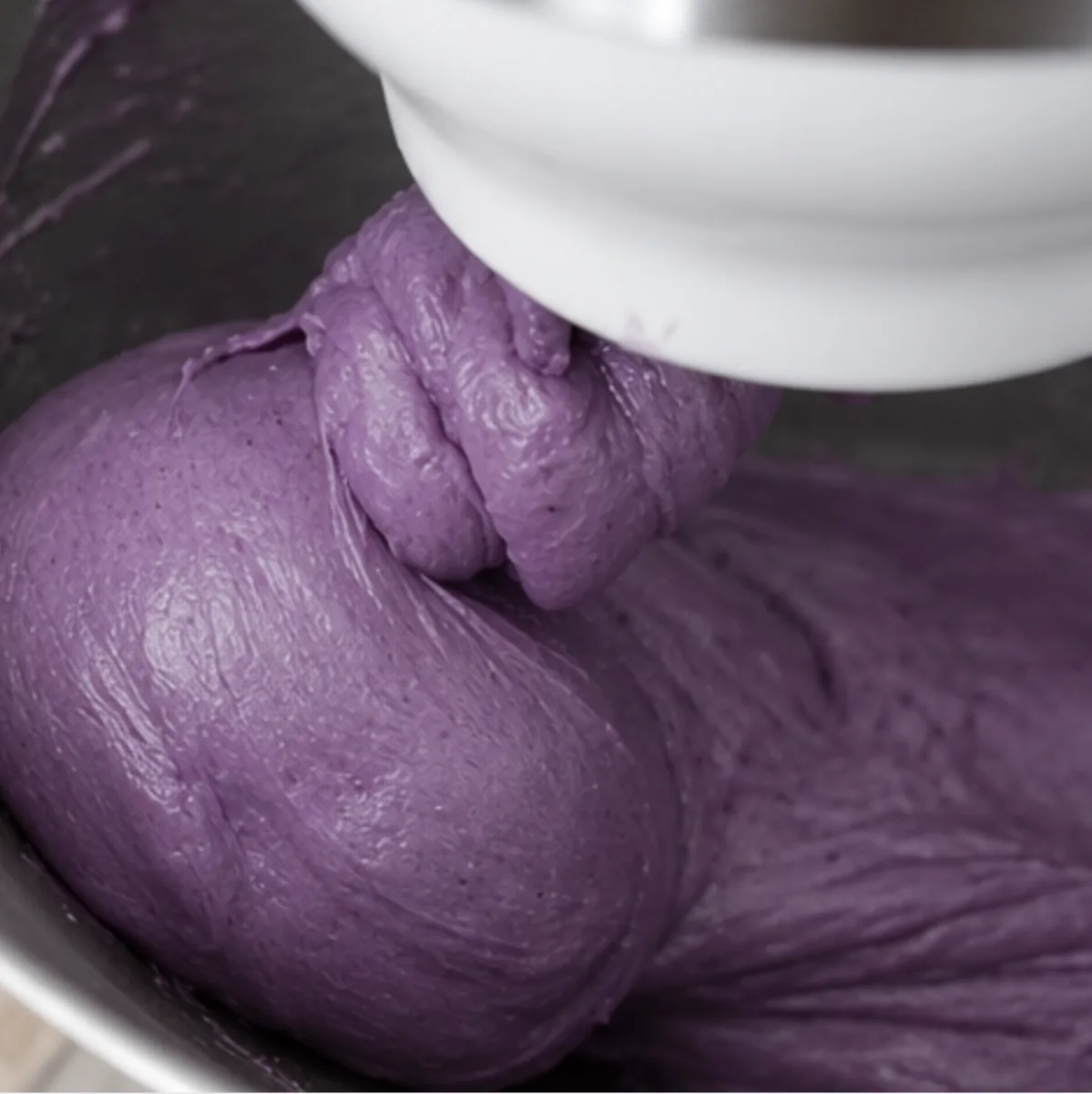 Kneading the Ube Nolia ube brioche dough with the dough hook of a stand mixer
