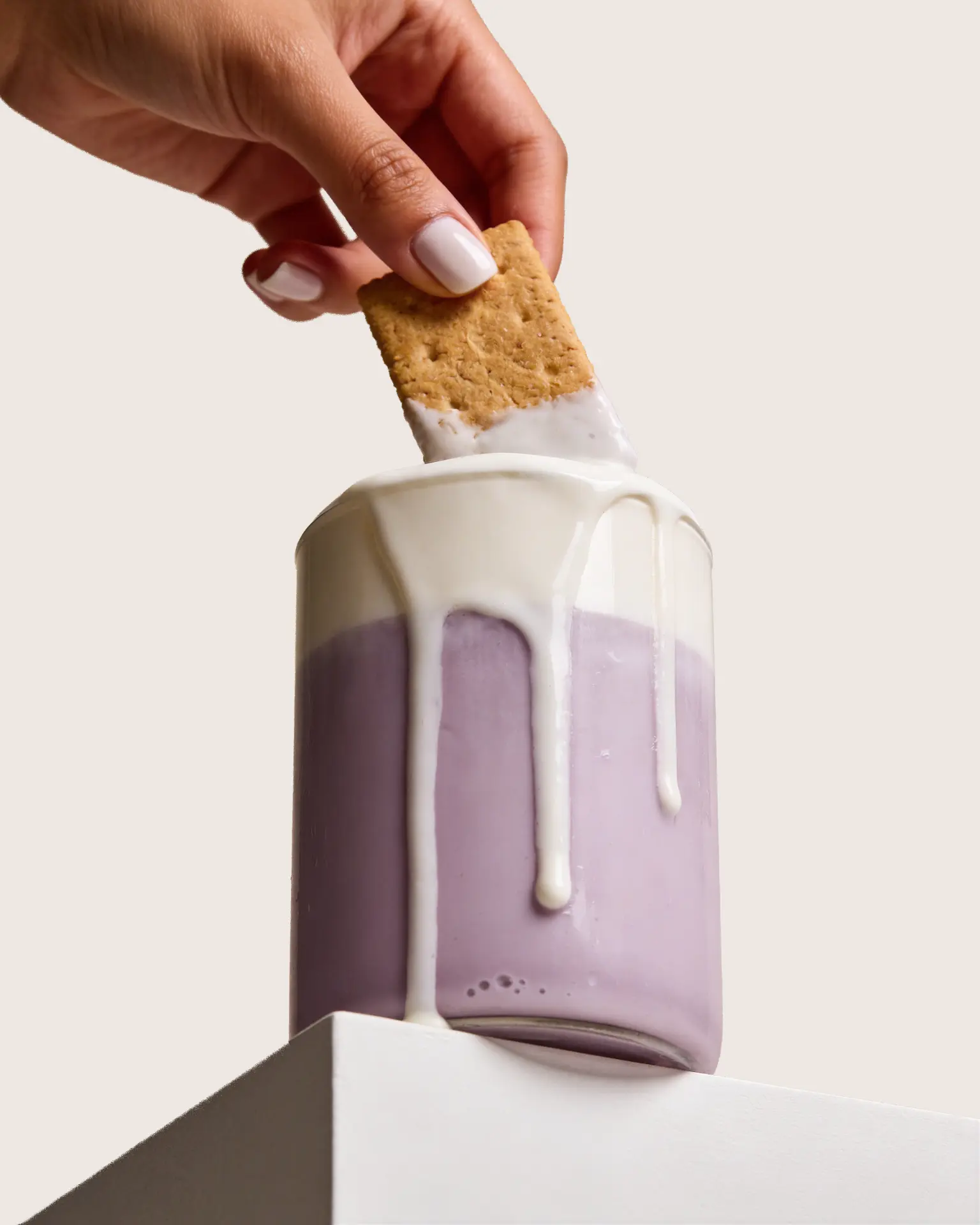 Graham cracker dipped into a creamy ube latte made with Ube Nolia ube powder | Ube Nolia