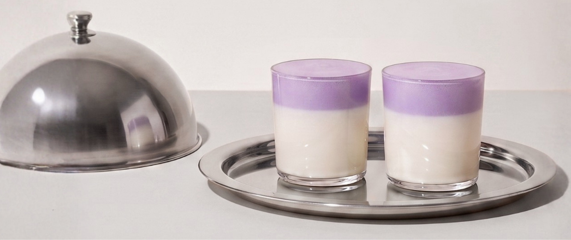 Ube Nolia loyalty program invitation with ube lattes on a silver tray