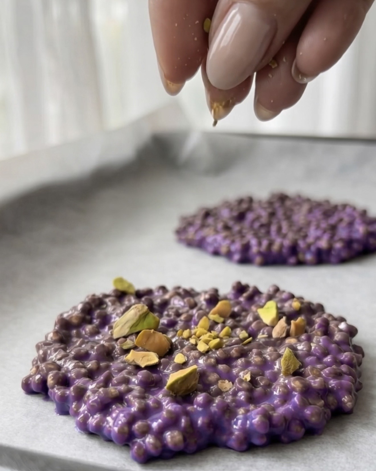 Crushed pistachios topping purple ube quinoa bites by Ube Nolia