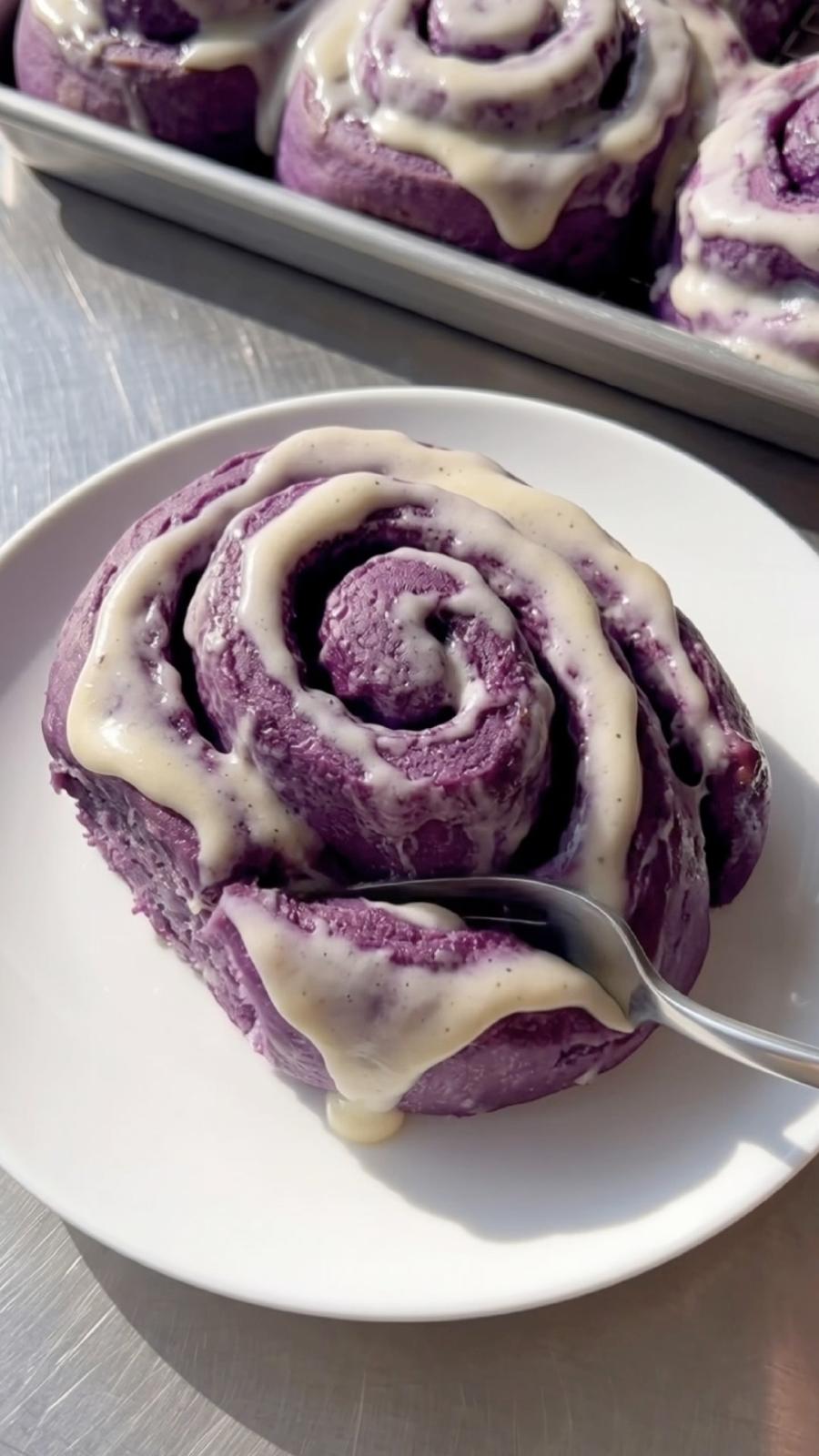 Tasting a soft Ube Nolia ube cinnamon roll with cream cheese frosting