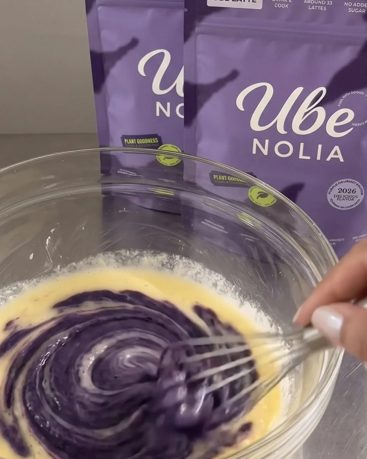 Whisking Ube Nolia ube powder into eggs, milk and butter for baked ube donuts