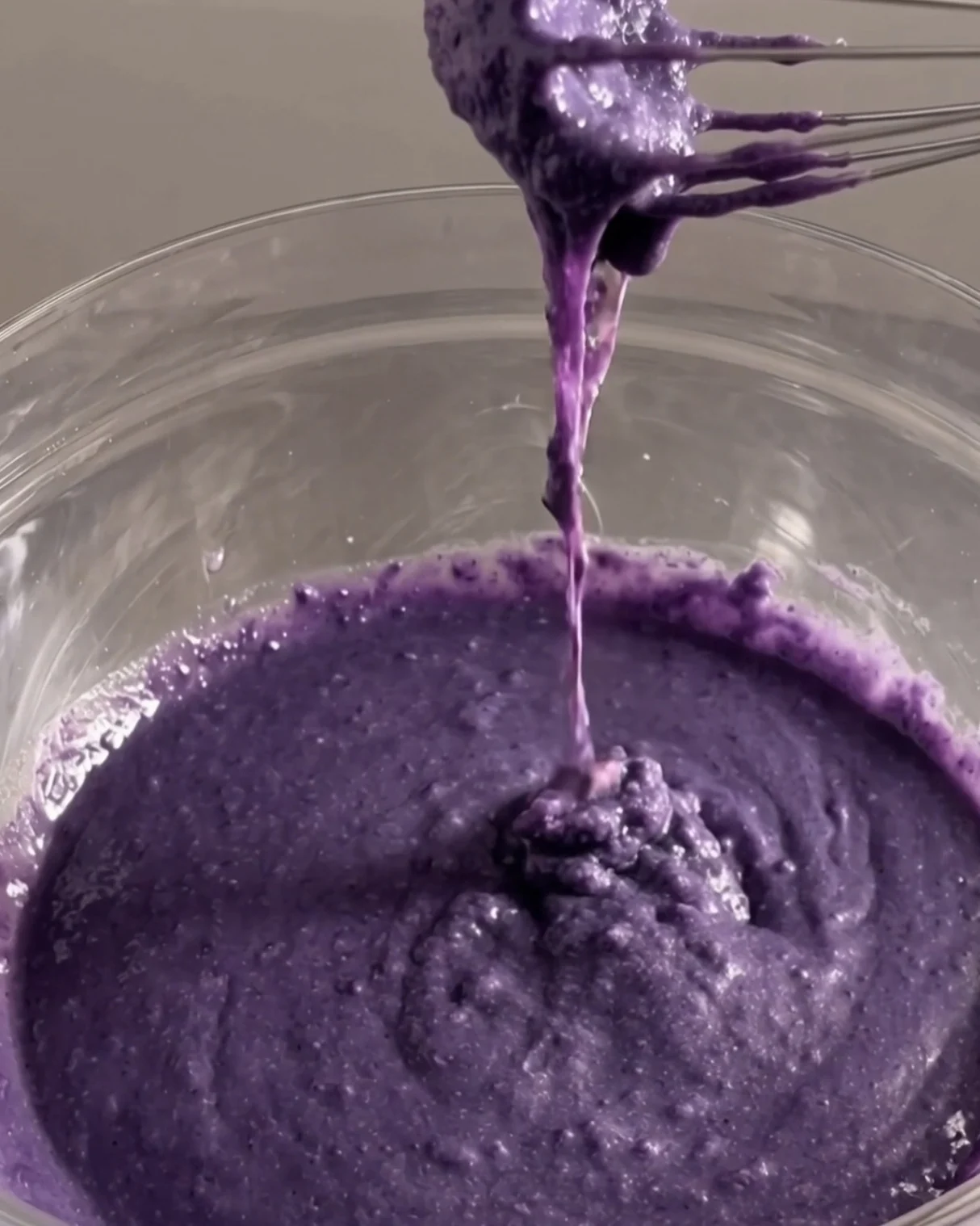 Thick purple ube donut batter falling off a whisk | Ube Nolia