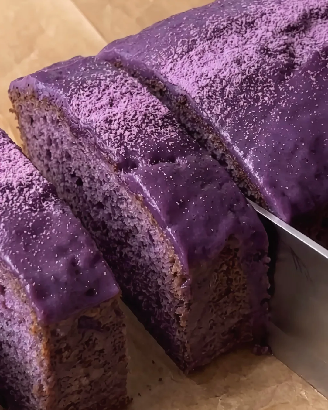 Sliced ube banana bread loaf with glossy ube glaze | Ube Nolia